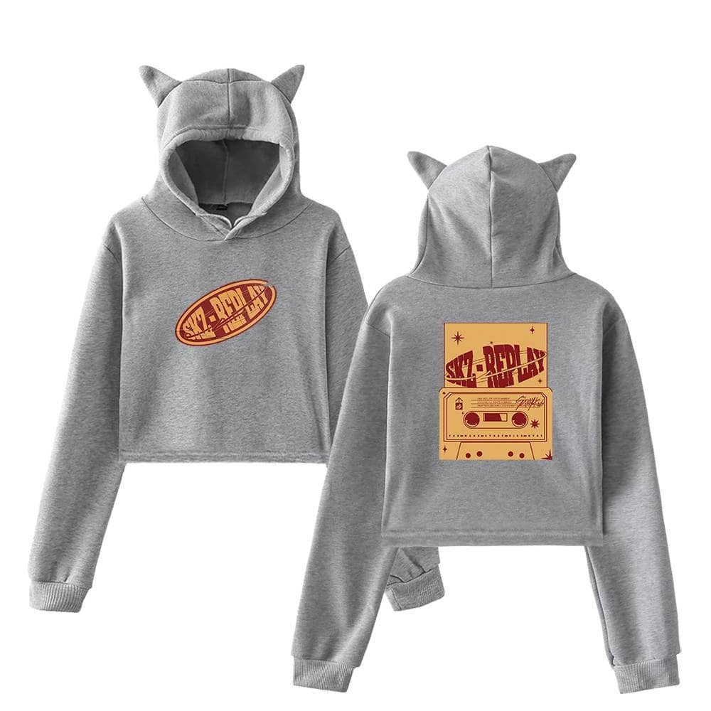 Comfortable gray hoodie and sweatpants set with cat ears, featuring a vintage cassette tape and "SKZ-REPLAY" graphic, perfect for K-pop fans.