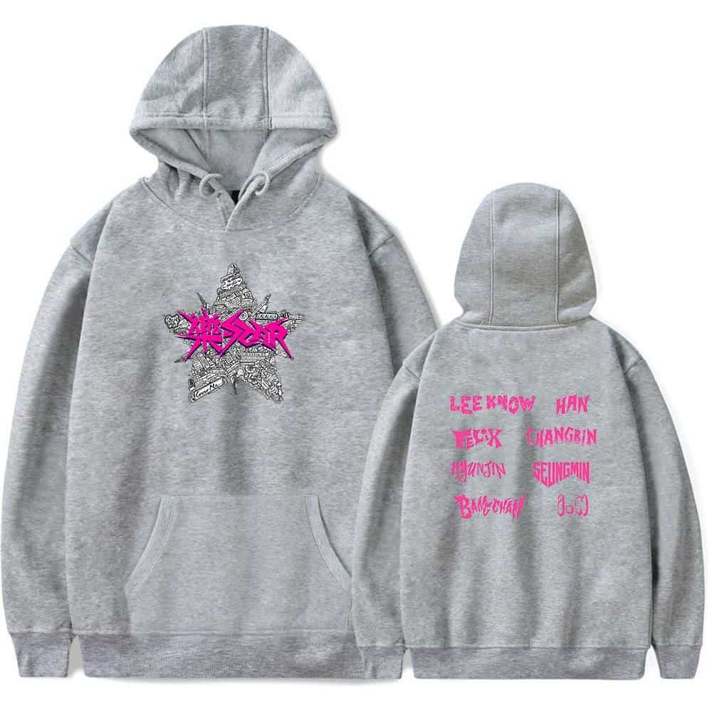 A grey hoodie with a pink and black graphic on the front and pink text listing K-pop idol names on the back.