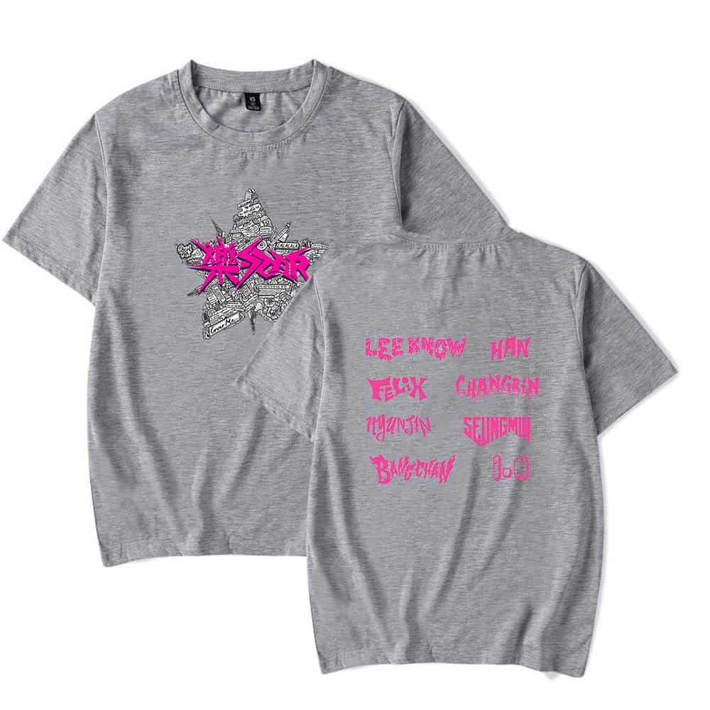 Kpop merch t-shirt with graphic and band names in pink on gray fabric.