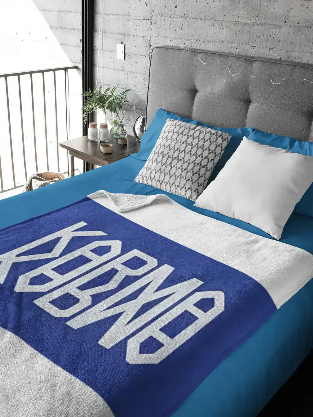 Sleek modern bedroom with gray upholstered headboard and vibrant blue bedding featuring K-pop merchandise logo.